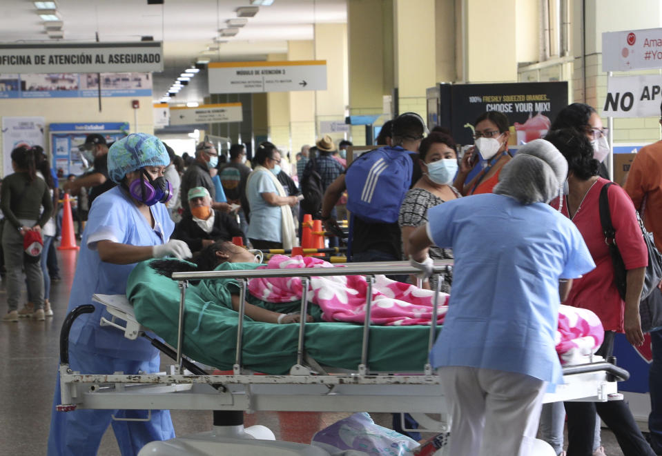 Nurses transport a patient amid the COVID-19 pandemic at the entrance of Alberto Sabogal Hospital in Callao, Peru, Monday, Jan 11, 2021. (AP Photo/Martin Mejia)