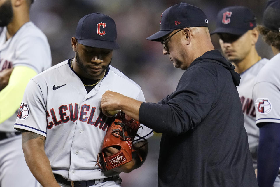 Cleveland Guardians manager Terry Francona, right, takes the baseball from relief pitcher Xzavion Curry during the sixth inning of the team's baseball game against the Arizona Diamondbacks on Friday, June 16, 2023, in Phoenix. (AP Photo/Ross D. Franklin)