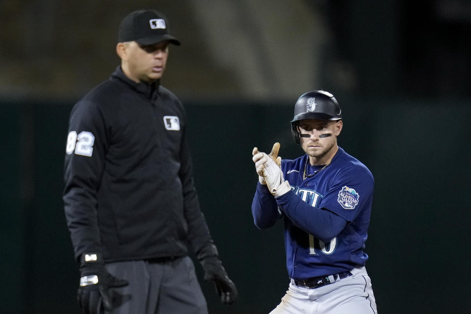 Seattle Mariners' Jarred Kelenic, right, celebrates after hitting an RBI double against the Oakland Athletics during the eighth inning of a baseball game in Oakland, Calif., Tuesday, May 2, 2023. (AP Photo/Godofredo A. Vásquez)