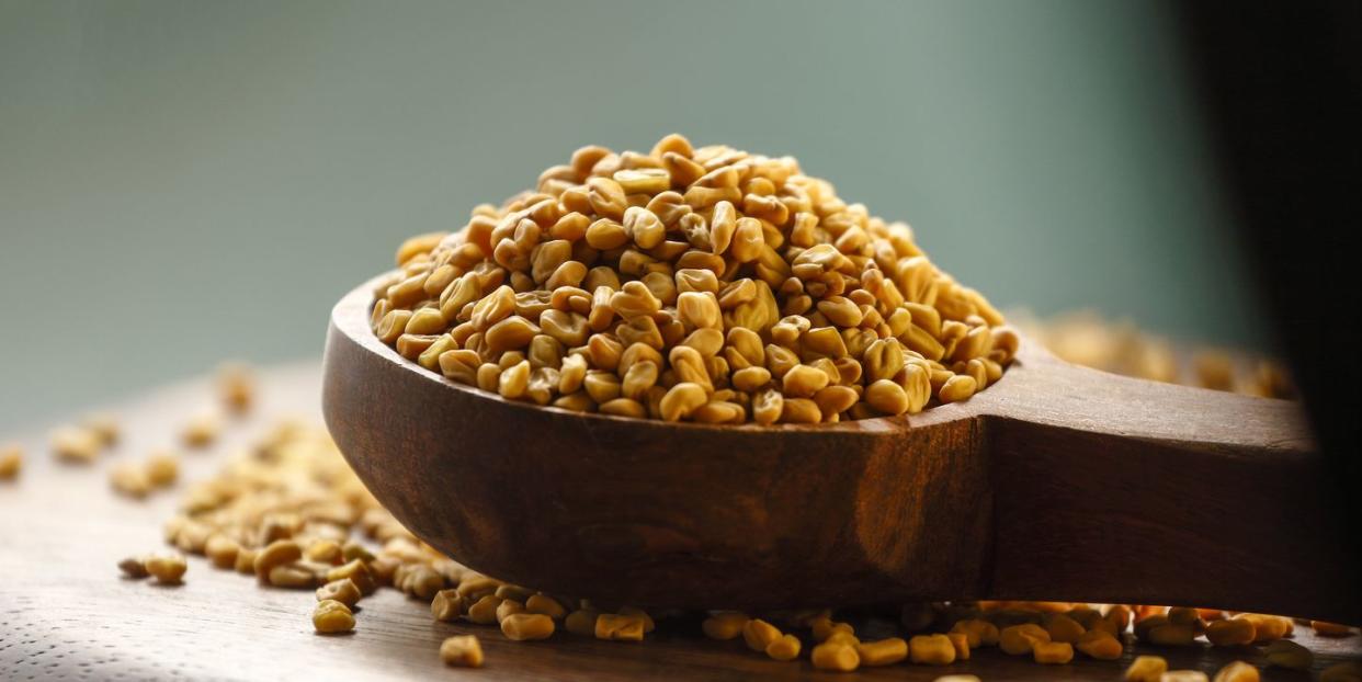 fenugreek seeds in wooden spoon