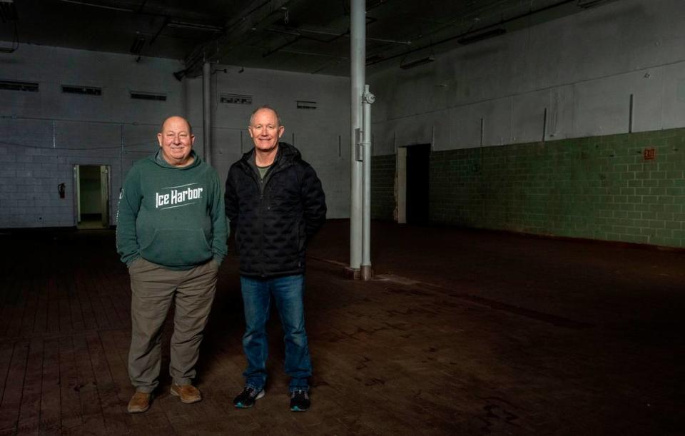 Mike Hall and Bill Jaquish, the co-owners of Ice Harbor Brewery, stand in part of the old Welch’s Grape Juice plant in downtown Kennewick. The building, which most recently housed JLieb Foods, Inc., will be the new flagship location of the Tri-Cities brewery.