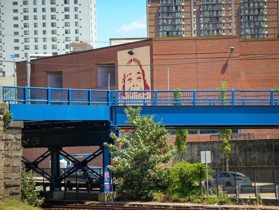 A mural of a Doran Community School student takes shape on the rear of the building, on July 22, 2022. It is being created by artist Kevin Ledo of Montreal.