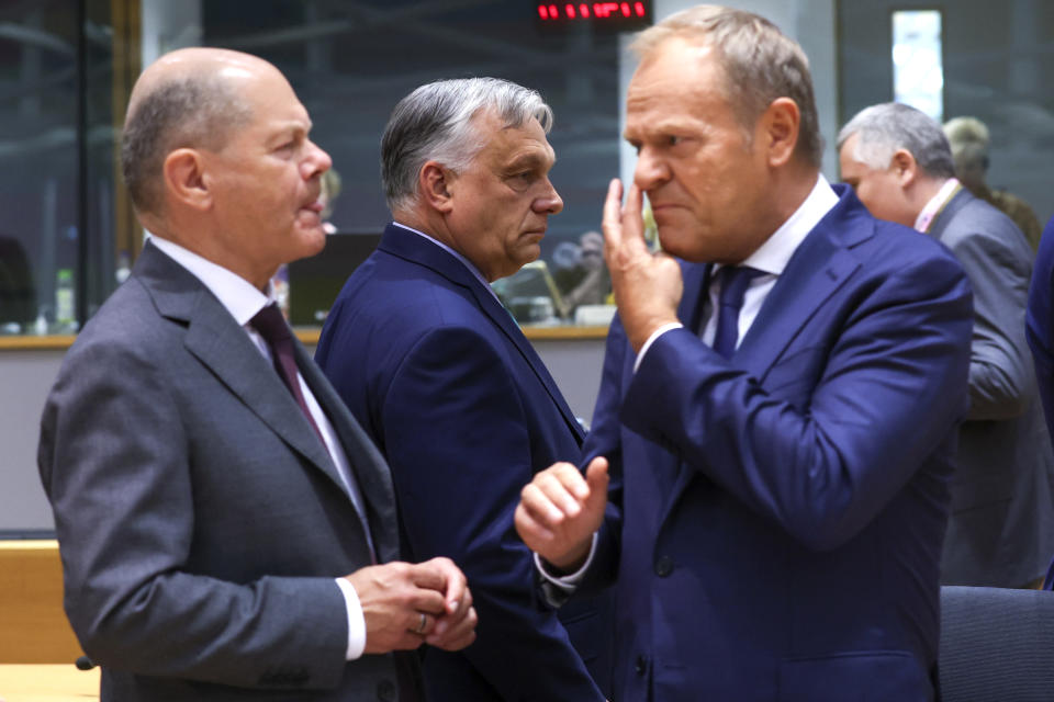 Poland's Prime Minister Donald Tusk, right, speaks with Germany's Chancellor Olaf Scholz, left, during a round table meeting at an EU summit in Brussels, Thursday, June 27, 2024. European Union leaders are expected on Thursday to discuss the next EU top jobs, as well as the situation in the Middle East and Ukraine, security and defence and EU competitiveness. (Olivier Hoslet, Pool Photo via AP)