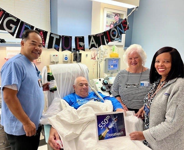 Ralph "Rocco" Russo, 77, center, of Marshfield, has made 550 blood platelet donations to the Kraft Family Blood Donor Center at Dana-Farber Cancer Institute in Boston over 27 years. From left are lead technician Someth Em; Russo; his wife, Annemarie; and technician Marie Fleurant.