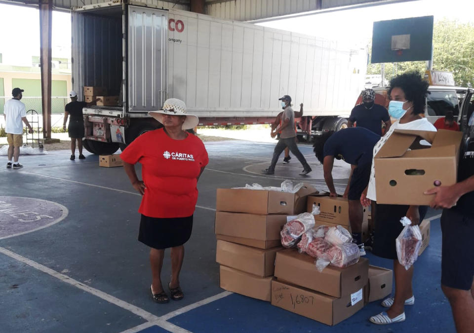 Volunteers unload boxes of food donations in Loiza, Puerto Rico. (Modesta Irizarry)