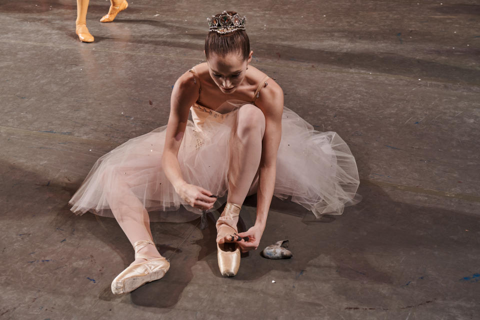 Unity Phelan adjusts her pointe shoe.