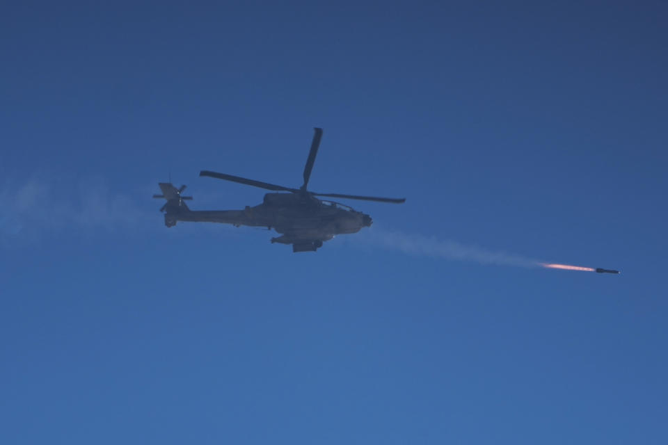 An Israeli Apache helicopter fires a missile in the direction of the Gaza Strip, as seen from southern Israel, Thursday, Jan. 4, 2024. (AP Photo/Ariel Schalit)