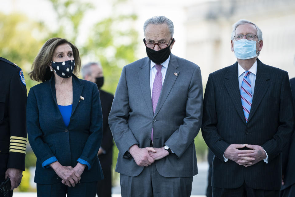 From left, House Speaker Nancy Pelosi of Calif., Senate Majority Leader Chuck Schumer of N.Y., and Senate Minority Leader Mitch McConnell of Ky., wait for the flag-draped casket of U.S. Capitol Police officer William "Billy" Evans, to be carried from the Capitol by a joint services honor guard Washington, Tuesday, April 13, 2021. (Jabin Botsford/The Washington Post via AP, Pool)