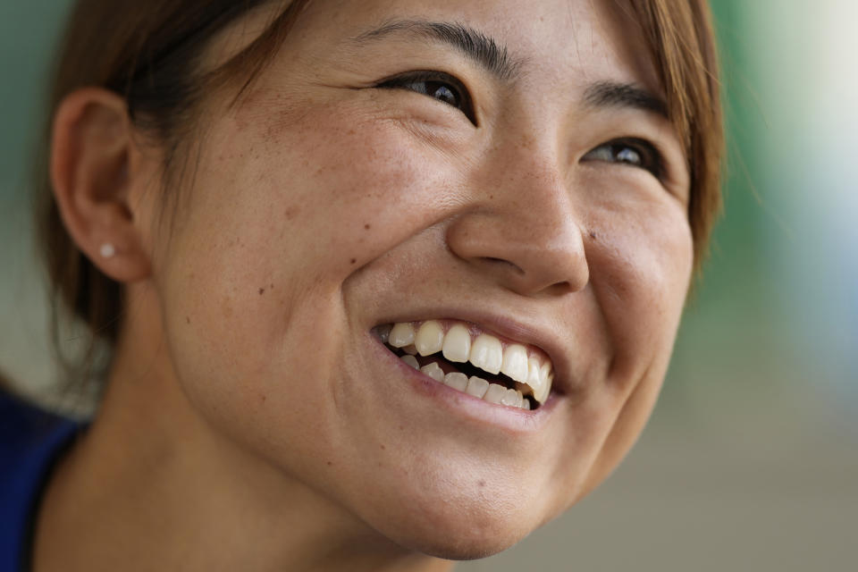 Eri Yoshida of a Japanese women's team, Agekke, smiles during an interview at her team practice field in Oyama, Tochigi prefecture, north of Tokyo, Tuesday, May 30, 2023. The 31-year-old Japanese woman is a knuckleball pitcher with a sidearm delivery that she hopes might carry her to the big leagues in the United States or Japan. (AP Photo/Shuji Kajiyama)