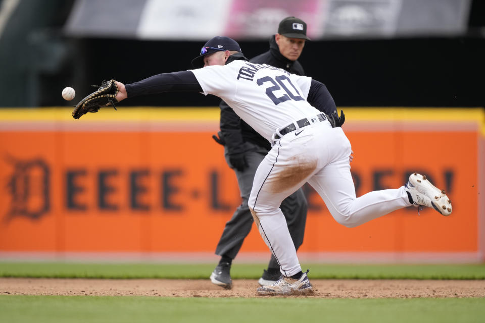 Detroit Tigers first baseman Spencer Torkelson stretches to catch the wide throw from third baseman Nick Maton to give Cleveland Guardians' Gabriel Arias a single during the fifth inning in the first game of a baseball doubleheader, Tuesday, April 18, 2023, in Detroit. (AP Photo/Carlos Osorio)