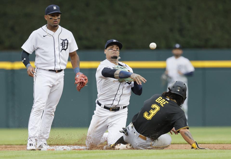 Tigers shortstop Javier Baez throws the ball for a double play after getting a force out on Pirates second baseman Ji Hwan Bae during the second inning on Tuesday, May 16, 2023, at Comerica Park.