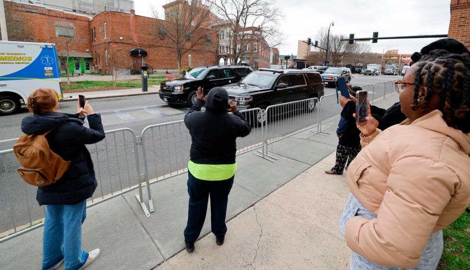 People wave as Vice President Kamala Harris’ motorcade passes on N. Magnum St. in Durham, N.C., Friday, March 1, 2024, Vice President Harris visited Ella West Art Gallery during a trip to announce the federal government is awarding $32 million to help women- and minority-led businesses in North Carolina.