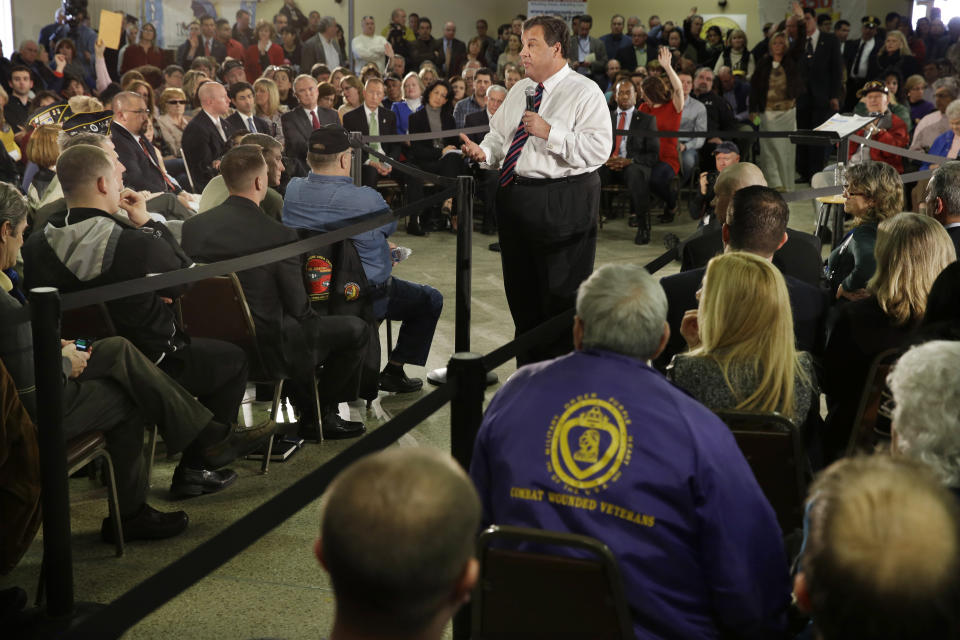 Gov. Chris Christie, center, addresses a large gathering Thursday, Feb. 20, 2014, in Middletown, N.J., during a town hall meeting. Christie returned to Republican-controlled Monmouth County on Thursday for his first town hall since private emails revealed a political payback scandal in which his associates ordered traffic lanes closed, causing lengthy backups. But the scandal didn't come up. Instead, the 51-year-old Republican heard from residents who have not returned to their homes since the 2012 storm. (AP Photo/Mel Evans)