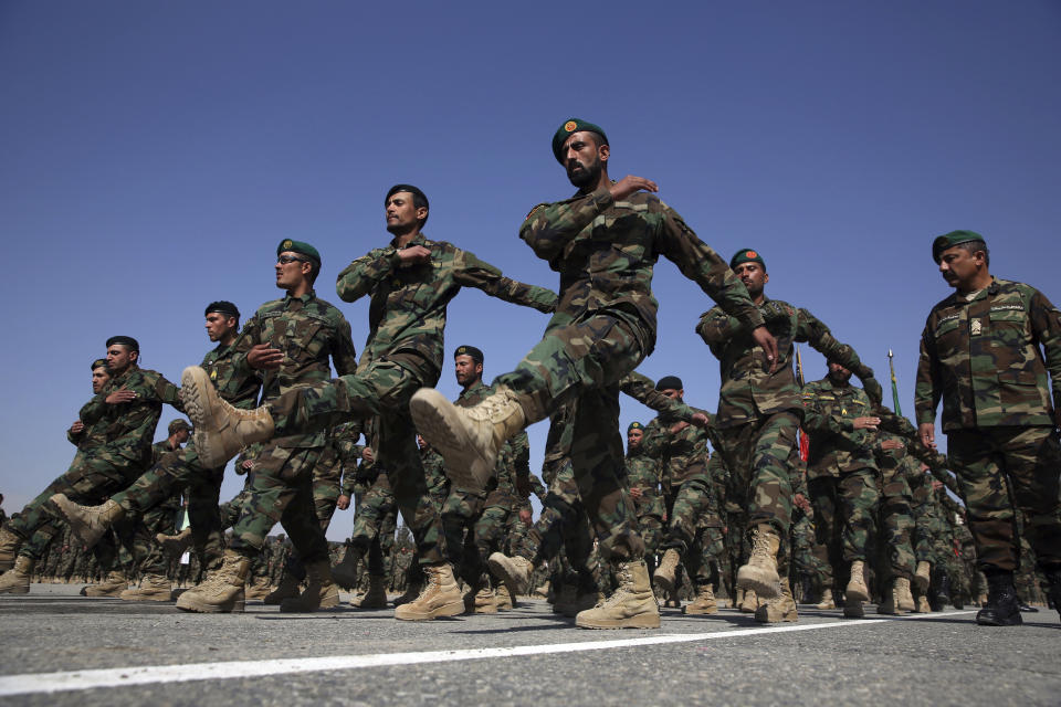 FILE - In this Monday, Feb. 24, 2020 photo, newly graduated Afghan National Army march during their graduation ceremony after a three month training program at the Afghan Military Academy in Kabul, Afghanistan. Many Afghans view Saturday's expected signing of a U.S.-Taliban peace deal with a heavy dose of well-earned skepticism. They've spent decades living in a country at war -- some their whole lives — and wonder if they can ever reach a state of peace. (AP Photo/Rahmat Gul, File)