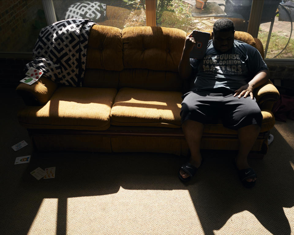 J.H. listens to music on his iPad in the sunroom at his home in Shreveport, Louisiana, on Aug. 25, 2019. (Photo: Cooper Neill for HuffPost)
