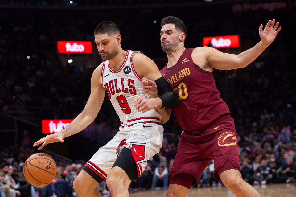 Chicago Bulls' Nikola Vucevic (9) is defended by Cleveland Cavaliers' Georges Niang during the second half Wednesday in Cleveland.