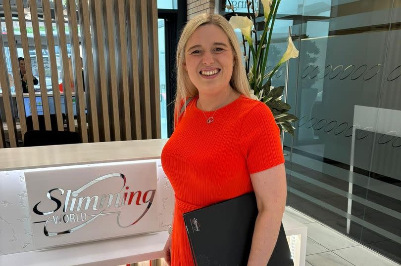 Sian wearing a red dress