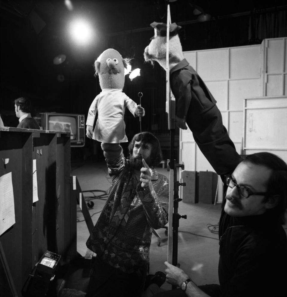 Jim Henson (holding an 'Anything Muppet' dentist) and Frank Oz (holding an 'Anything Muppet' postman) take their posts during rehearsal. 