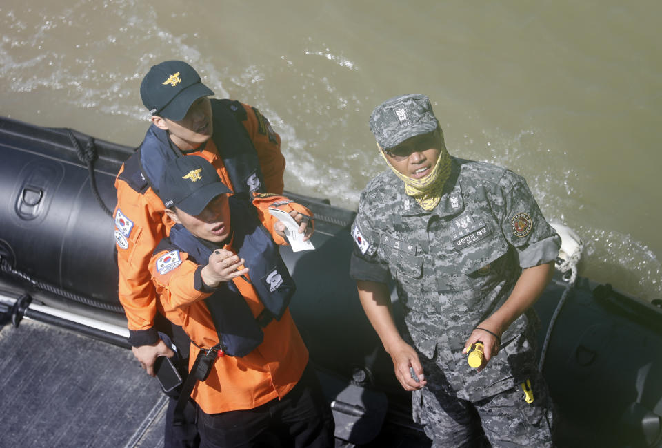 South Korean rescue team inspects the site of a ship accident on the Danube river where a sightseeing boat capsized in Budapest, Hungary, Saturday, June 1, 2019. As divers descended Friday into the Danube, Hungarian authorities predicted it would take an extended search to find the 21 people still missing after a boat carrying South Korean tourists was rammed by a cruise ship and sank into the river in Budapest. (AP Photo/Laszlo Balogh)