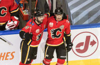 Calgary Flames' Mark Giordano (5) and Mikael Backlund (11) celebrate a goal against the Winnipeg Jets during the second period of an NHL hockey playoff game Saturday, Aug. 1, 2020 in Edmonton, Alberta. (Jason Franson/The Canadian Press via AP)
