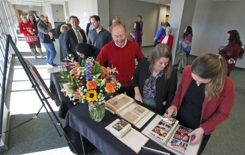 People line up to sign in and check out old photos and newspaper clippings concerning the long career of District Court Judge Mike Lands prior to a retirement event held Friday afternoon, Dec. 16, 2022, at the Gaston County Courthouse. A former public defender, Lands was the county's district attorney for 16 years, starting in 1991, and then a judge for 16 years. He retires at the end of the year.