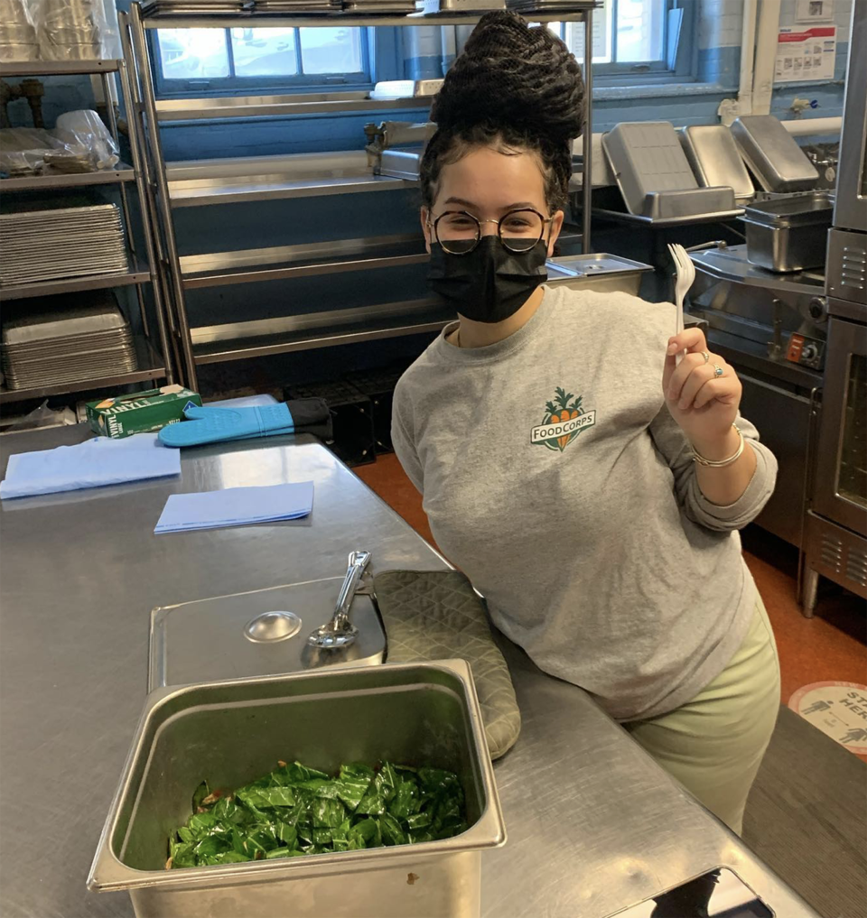 Brooks tests collard greens as part of a Black History Month lesson by FoodCorps and Grow Initiative. (Courtesy Shalynn Brooks / FoodCorps)