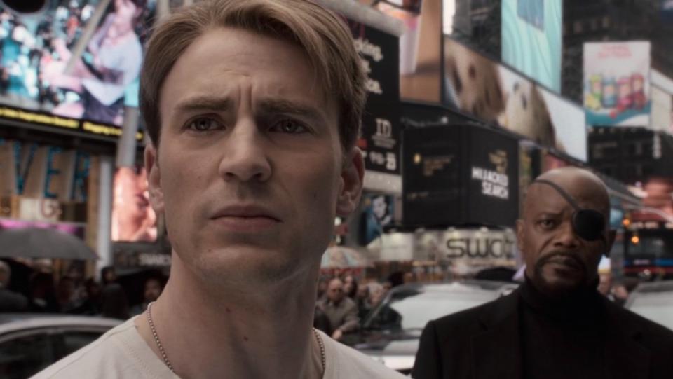 Steve Rogers looks disappointed in Times Square as Nick Fury looks on in Captain America: The First Avenger