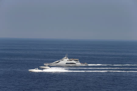 Iranian Revolutionary Guards speed boats are seen near the USS John C. Stennis CVN-74 (not pictured) as it makes its way to gulf through strait of Hormuz, December 21, 2018. REUTERS/Hamad I Mohammed