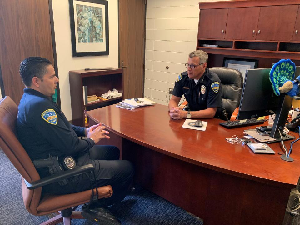 Lt. Frank Browning and Chief Andy Mills discuss the "Shop With a Cop" fundraising event.