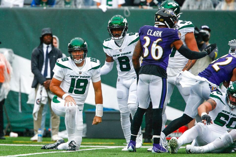 Jets receiver Elijah Moore (8) helps up quarterback Joe Flacco (19) after Flacco threw an interception against the Baltimore Ravens, Sept. 11, 2022, in East Rutherford, N.J.