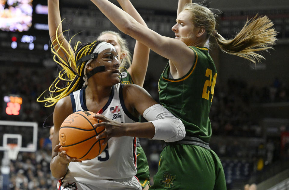 UConn's Aaliyah Edwards, left, is guarded by Vermont's Anna Olson in the first half of the first round of the NCAA women's tournament on March 18, 2023, in Storrs, Connecticut. (AP Photo/Jessica Hill)