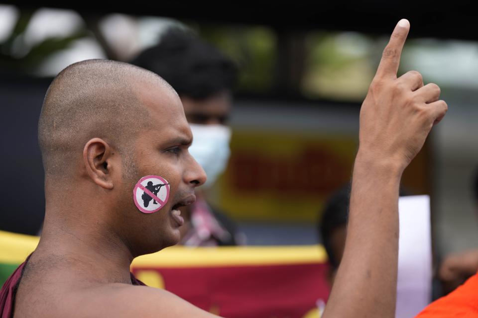 A protesting monk shouts anti-government slogans during a protest against military eviction of protesters from the president's office in Colombo, Sri Lanka, Friday, July 22, 2022. (AP Photo/Eranga Jayawardena)