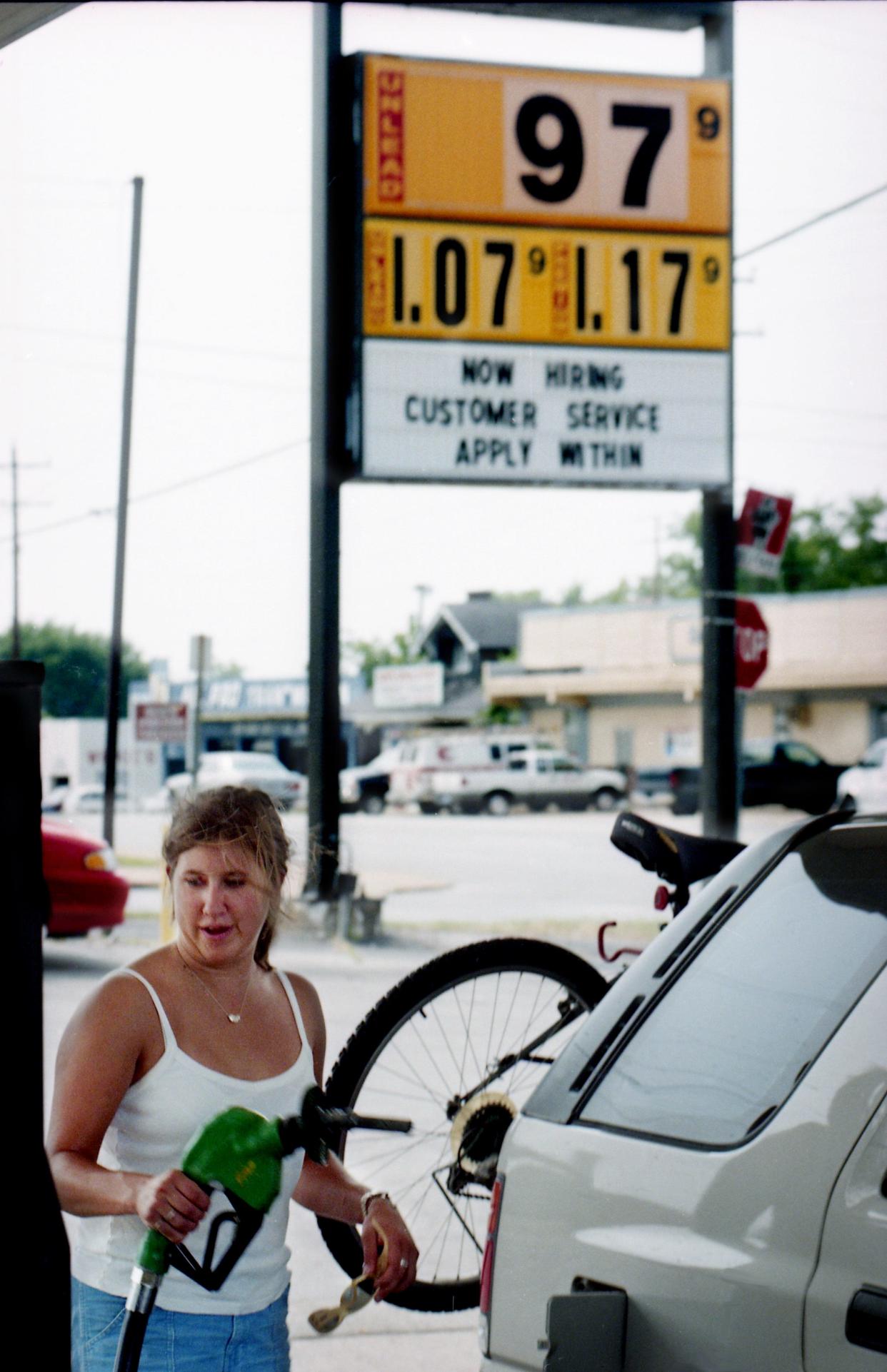 Flashback: Jennifer Larson, 21, of Boulder, Colo., is finishing up filling her car at the Mapco station on Charlotte Avenue in Nashville May 20, 1998. She is on her way to Wrightsville Beach, N.C., for a summer job. Record numbers of motorists are expected to drive to their upcoming Memorial Day vacations with the least expensive gasoline in a decade.