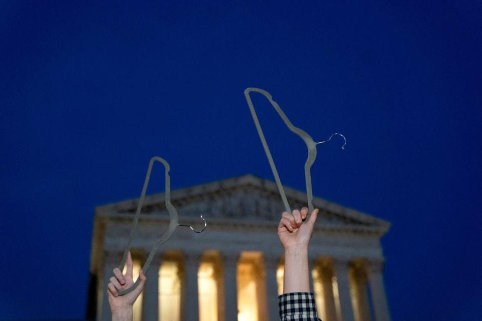 Pro-choice demonstrators hold coat hangers, a symbol of the reproductive rights movement, outside the U.S. Supreme Court in Washington, D.C., on May 3.