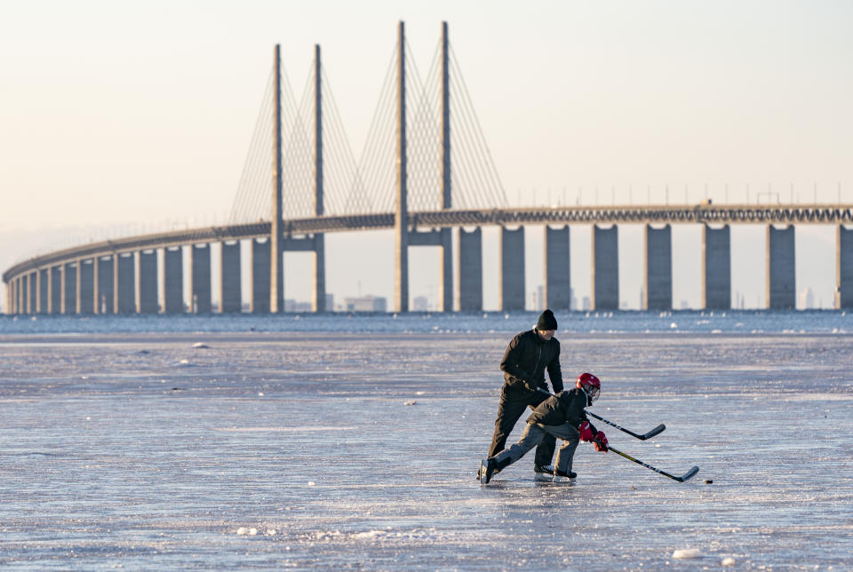 Skaters play hockey on the ice that settled on the Oresund strait, Wednesday Feb, 10, 2021, at Bunkeflostrand a suburb of Malmo, Sweden, south of the Oresund Bridge. (Johan Nilsson/TT via AP)