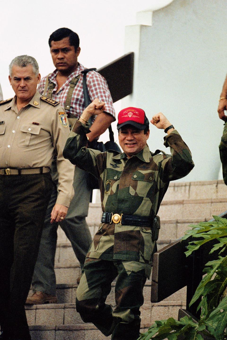 <p>Panamanian Gen. Manuel Antonio Noriega emerges from his military headquarters in Panama City, Oct. 4, 1989, a day after a failed coup attempt. President George H.W. Bush refuses to rule out military action to oust the leader, but the next U.S. moves are more likely to involve dollars than bullets. (AP Photo/John Hopper) </p>