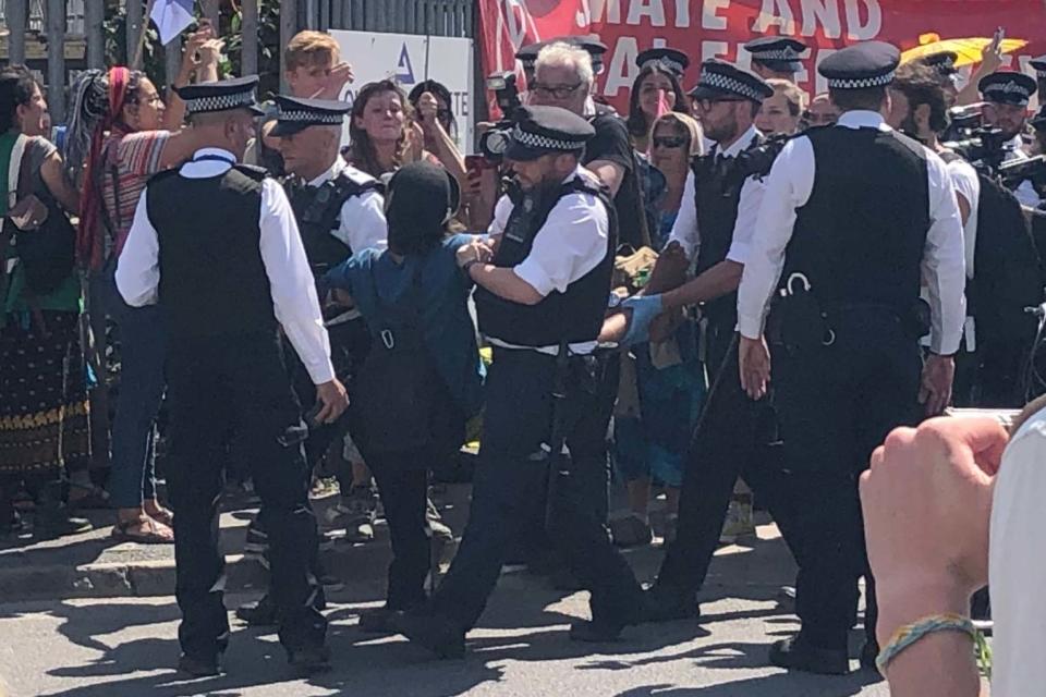 Six Extinction Rebellion protesters have been arrested after they blocked the entrances to a concrete works in east London. The group gathered outside London Concrete in Bow, where vehicles were backed up and unable to get in due to the activists blocking their way. They were protesting the environmental impacts of concrete production, bemoaning its contribution to air pollution in the area, though a spokeswoman for the site said it was at "the forefront of efforts to mitigate climate change". Those gathered outside said they wanted to "non-violently disrupt the site" and one said: "We're going to be here all day if we have to be."Scotland Yard said there had been six arrests at the protest. > Both entrances to London Concrete in Bow currently blocked by peaceful rebels! SummerUprising ActNow pic.twitter.com/vJDfgIIgfP> > — Extinction Rebellion London (⧖) (@LdnRebellion) > > July 16, 2019"In the early hours of this morning, protestors congregated at the entrance of the construction site which prevented companies within the area from being able to go about their daily business," a statement regarding the arrests said. "As a result, a total of six people - three men and three women, aged between 30 and 67 - were arrested on suspicion of aggravated trespassing and obstruction of a highway and taken into custody."After the arrests, Met Police Commander Jane Connors, said: “We absolutely recognise the right for people to protest however we will continue to take action against those who choose to break the law, to ensure disruption to Londoners is kept to a minimum.“Police Liaison Teams remain in contact with organisers to understand their plans and ensure London remains open for business.”Extinction Rebellion previously said around 50 people, nicknamed rebels by the group, had gathered outside. Some of them had locked themselves to each other in the action, which is part of the activists' "summer uprising". A line of protesters held a sign which read "the air that we grieve" and another pair held one which said: "Silvertown Tunnel no."In a statement, Eleanor McAree, 25, from Extinction Rebellion Tower Hamlets, said: “Concrete has a huge environmental impact and building another tunnel will only make air pollution across East London worse."The air pollution is already at dangerous levels and is affecting the health of children and adults in the area. With the siting of this industry right next to two schools, these children face lifelong negative impact on their health.”> Officers are currently dealing with two XR Rebellion protest locations in Bow where premises related to the construction industry have been targeted. > A number of arrests have been made and officers remain at these locations.> > — MPS Events (@MetPoliceEvents) > > July 16, 2019An Extinction Rebellion source earlier told the Standard today's actions in London would be "all about concrete". Outlining why they picked the site, they detailed links to the Silvertown Tunnel project, which will see a toll road built under the Thames. A spokeswoman for London Concrete previously said: "We confirm there are currently peaceful protests taking place outside of our London Concrete premises in Bow, East London and we are cooperating with authorities on this matter.​"We are cognisant of the carbon footprint of cement and concrete and we are at the forefront of efforts to mitigate climate change."Extinction Rebellion began its five-day summer uprising on Monday, with actions in London, Glasgow, Cardiff, Bristol and Leeds. The group has used brightly coloured boats to block roads in each of the cities so far.