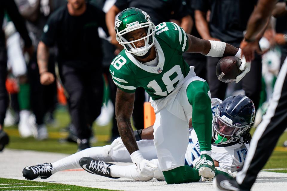 New York Jets wide receiver Mike Williams (18) gets up after receiving a pass over Tennessee Titans cornerback Chidobe Awuzie (13) during the fourth quarter at Nissan Stadium in Nashville, Tenn., Sunday, Sept. 15, 2024.