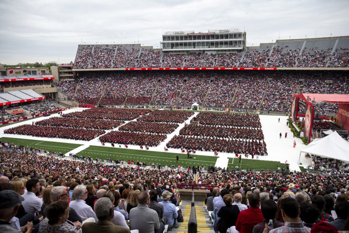 Attendees watch the 170th University of Wisconsin-Madison commencement ceremony at Camp Randall Stadium in Madison, Wis., on May 13, 2023. (Samantha Madar/Wisconsin State Journal via AP, File)