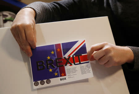 James Blake from emergency food storage.co.uk sticks a label on the company's 'Brexit Box' which contains dehydrated food, water purifying kit and fire starting gel at their warehouse in Leeds, Britain January 21, 2019. REUTERS/Phil Noble