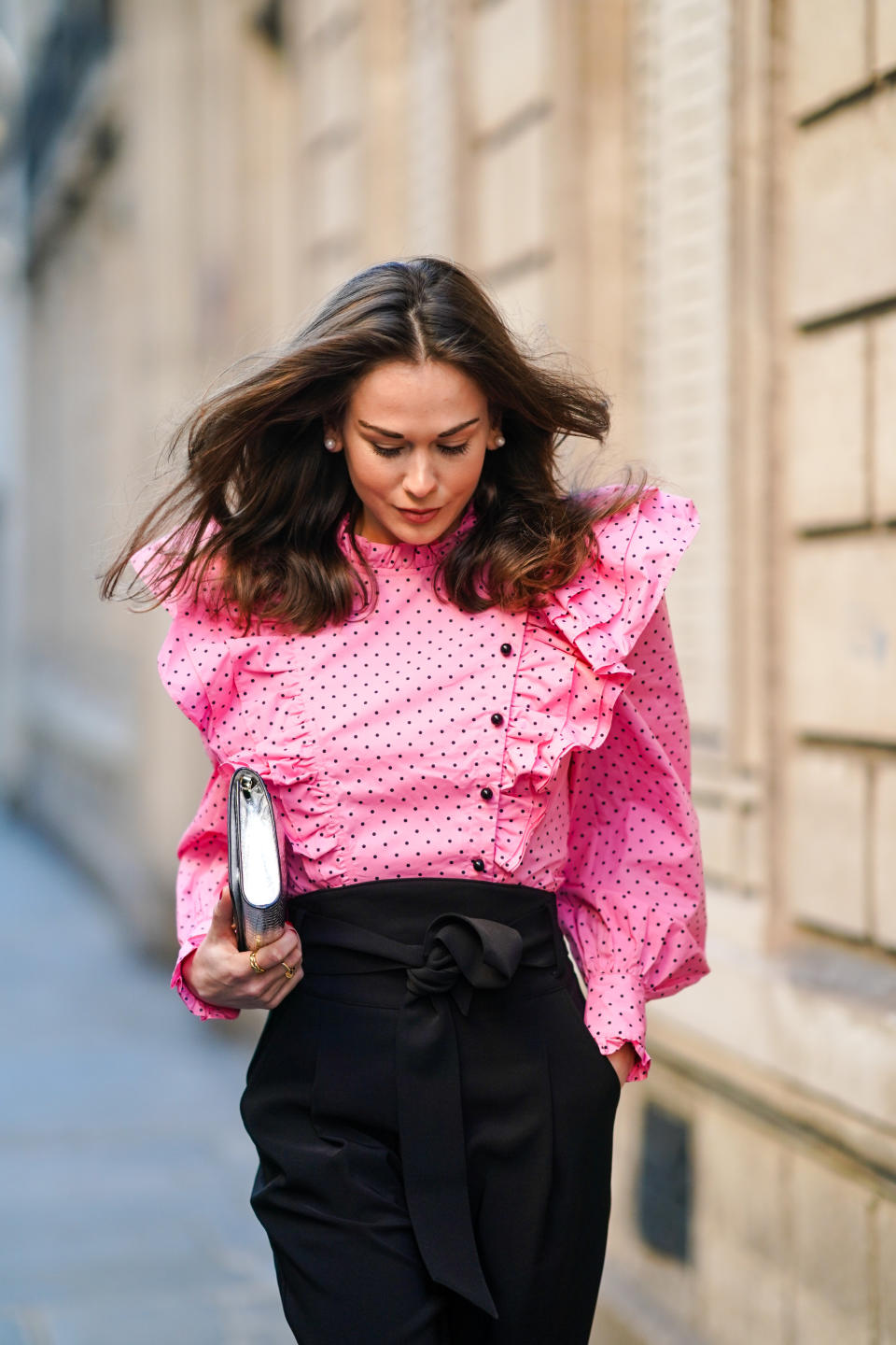 PARIS, FRANCE - NOVEMBER 28: Therese Hellström wears a full Custommade look made of a neon pink ruffled oversized top with puff sleeves and printed polka dots, black pants, a silver shiny crocodile pattern Jimmy Choo bag, on November 28, 2020 in Paris, France. (Photo by Edward Berthelot/Getty Images)