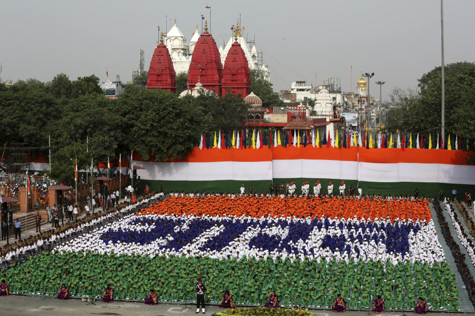 Indian children sit in formation to spell out the Hindi word "Bharat", which is the name of the country as they listen to Indian Prime Minister Narendra Modi address the nation on the country's Independence Day from the ramparts of the historical Red Fort in New Delhi, India, Wednesday, Aug. 15, 2018. (AP Photo/Manish Swarup)