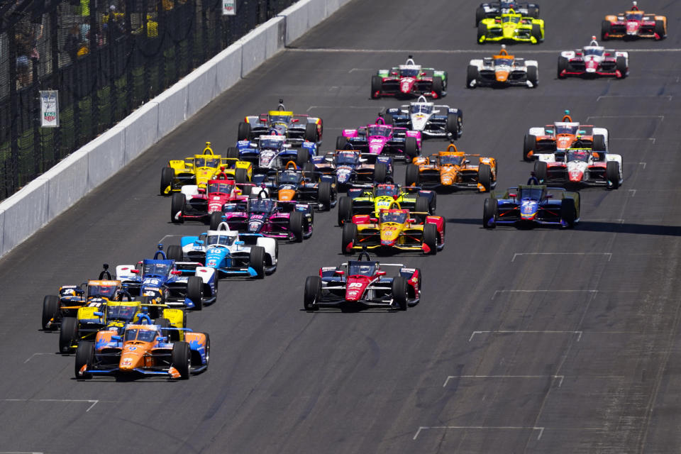 Scott Dixon of New Zealand leads the field into the first turn on the start the Indianapolis 500 auto race at Indianapolis Motor Speedway in Indianapolis, Sunday, May 30, 2021. Scott Dixon's perfect Indianapolis 500 fell apart when the six-time IndyCar Series champion ran out of gas before his first pit stop. (AP Photo/Paul Sancya)