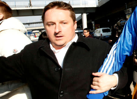 FILE PHOTO: Canadian businessman Michael Spavor arrives next to the former NBA basketball player Dennis Rodman (not pictured) after a trip to North Korea, at Beijing Capital International Airport, Beijing, China January 13, 2014. REUTERS/Kim Kyung-Hoon/File Photo