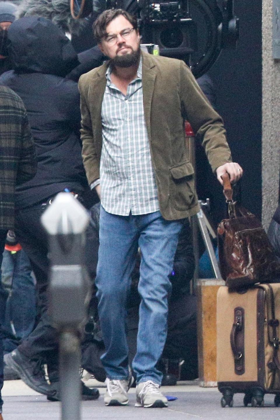 <p>Leonardo DiCaprio gets into character while filming a scene for <em>Don't Look Up</em> in downtown Boston on Monday. </p>