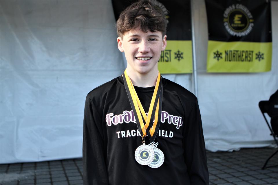 Myles Hogan, a Hastings resident, Fordham Prep senior and future Princeton runner, wears his medals after qualifying in Van Cortlandt Park in the Bronx for next month's Foot Locker Cross-Country Championships in San Diego, California. Hogan was fourth out of 237 male finishers.