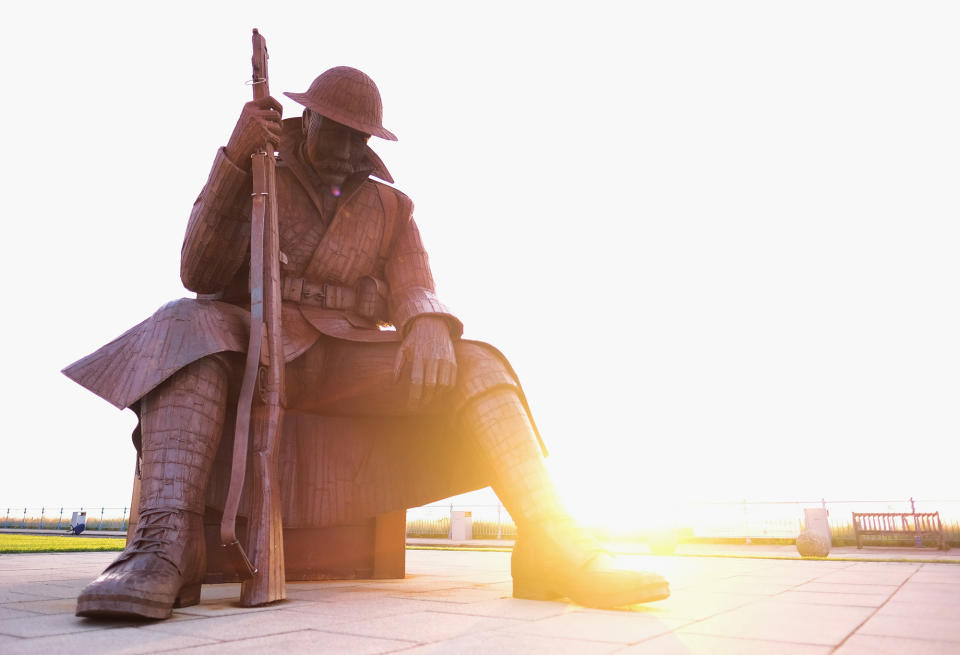 Dawn Breaks Over The Statue Of A First World War Soldier