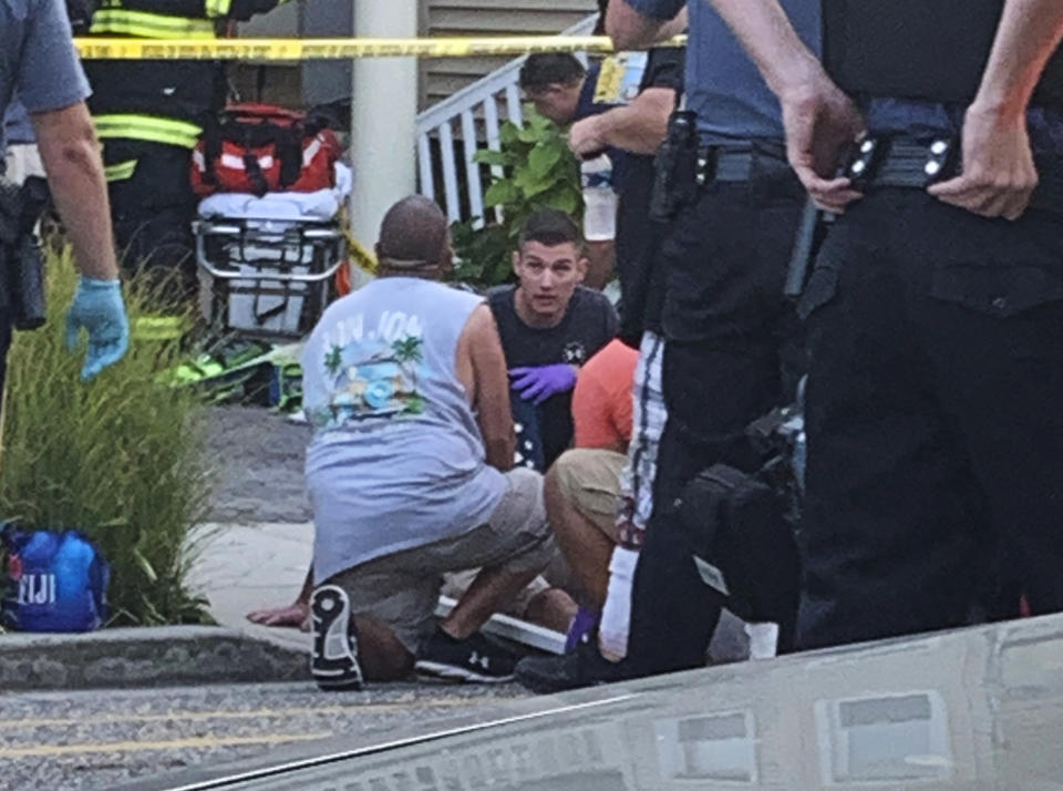 In this photo provided by James Macheda, first responders treat an injured person as they work the scene of a building structure damage in Wildwood, N.J., Saturday, Sept. 14, 2019. Multiple levels of decking attached to a building collapsed Saturday evening at the Jersey Shore, trapping people and injuring several, including children, officials and witnesses said. (James Macheda via AP)