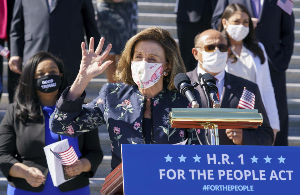 Speaker of the House Nancy Pelosi, D-Calif., and the Democratic Caucus gather to address reporters on H.R. 1, the For the People Act of 2021, at the Capitol in Washington, Wednesday, March 3, 2021. House Democrats are expected to pass a sweeping elections and ethics bill, offering it up as a powerful counterweight to voting rights restrictions advancing in Republican-controlled statehouses. (AP Photo/J. Scott Applewhite)