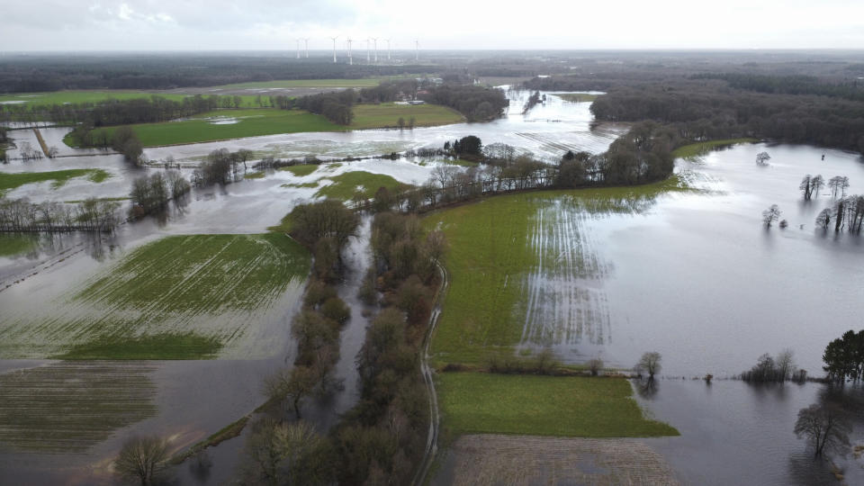 The small river Hunte has burst its banks near Oldenburg and is flooding the surrounding meadows and fields in Huntlosen, Germany, Wednesday, Jan. 3, 2024. (Christian Charisius/dpa via AP)